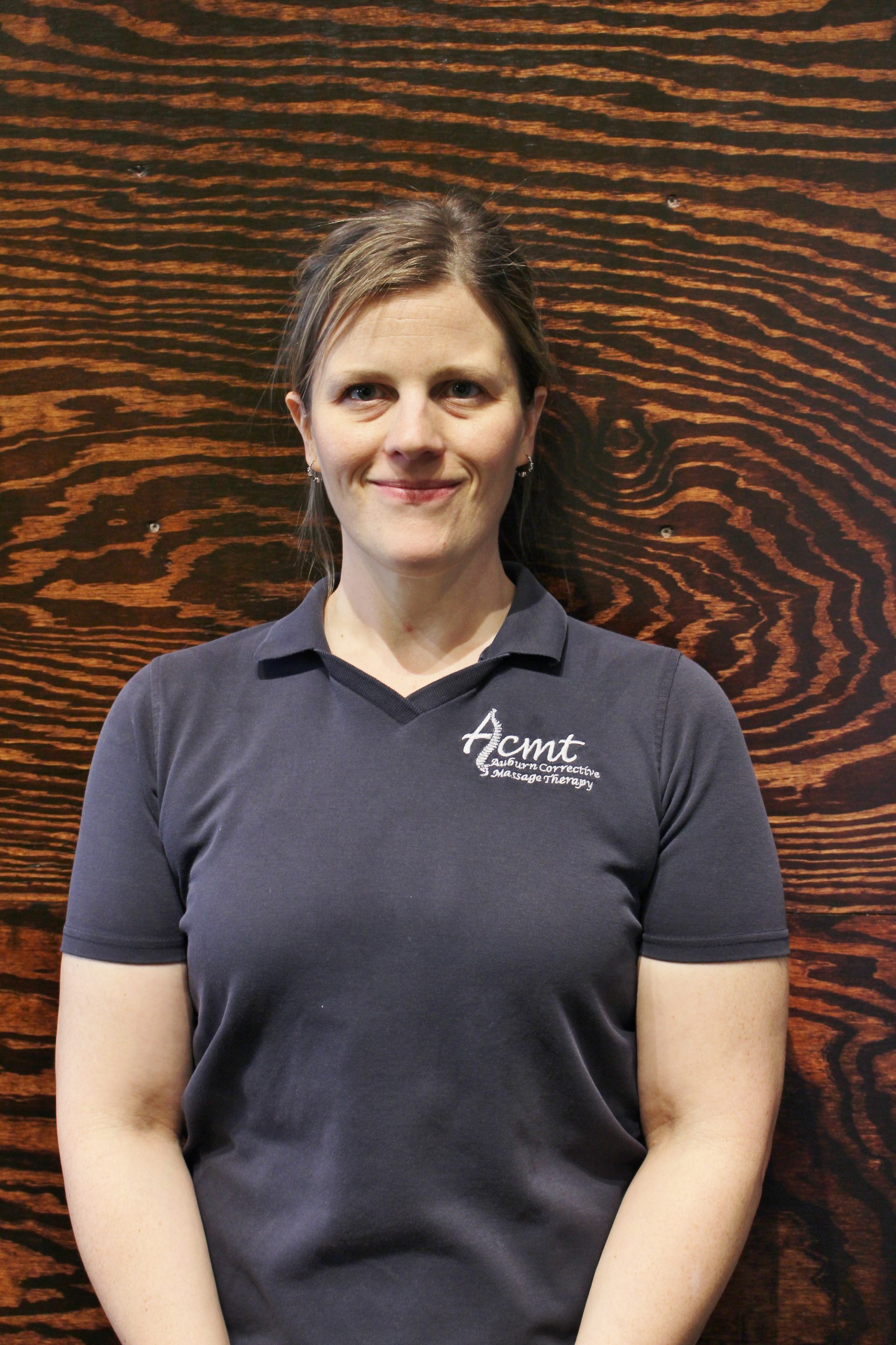 Woman smiling in dark polo

